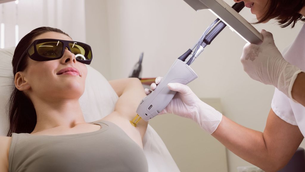 A young woman is taking Laser hair removal treatment at the clinic
