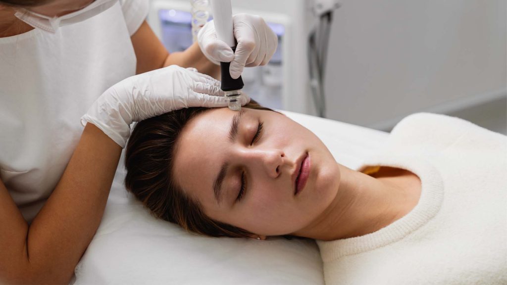 A woman is getting laser skin rejuvenation treatment at Amara Aesthetic Studio